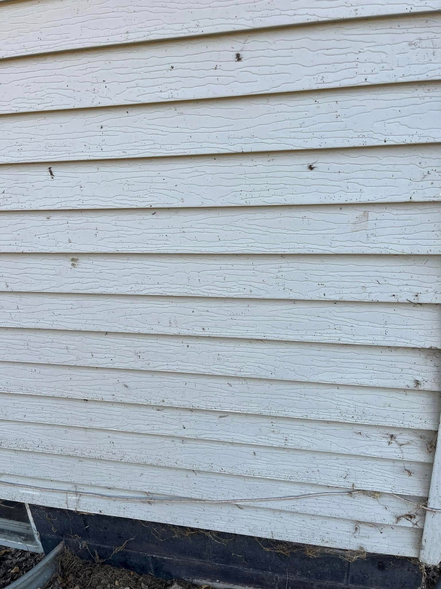 A close up of a white siding on a house.
