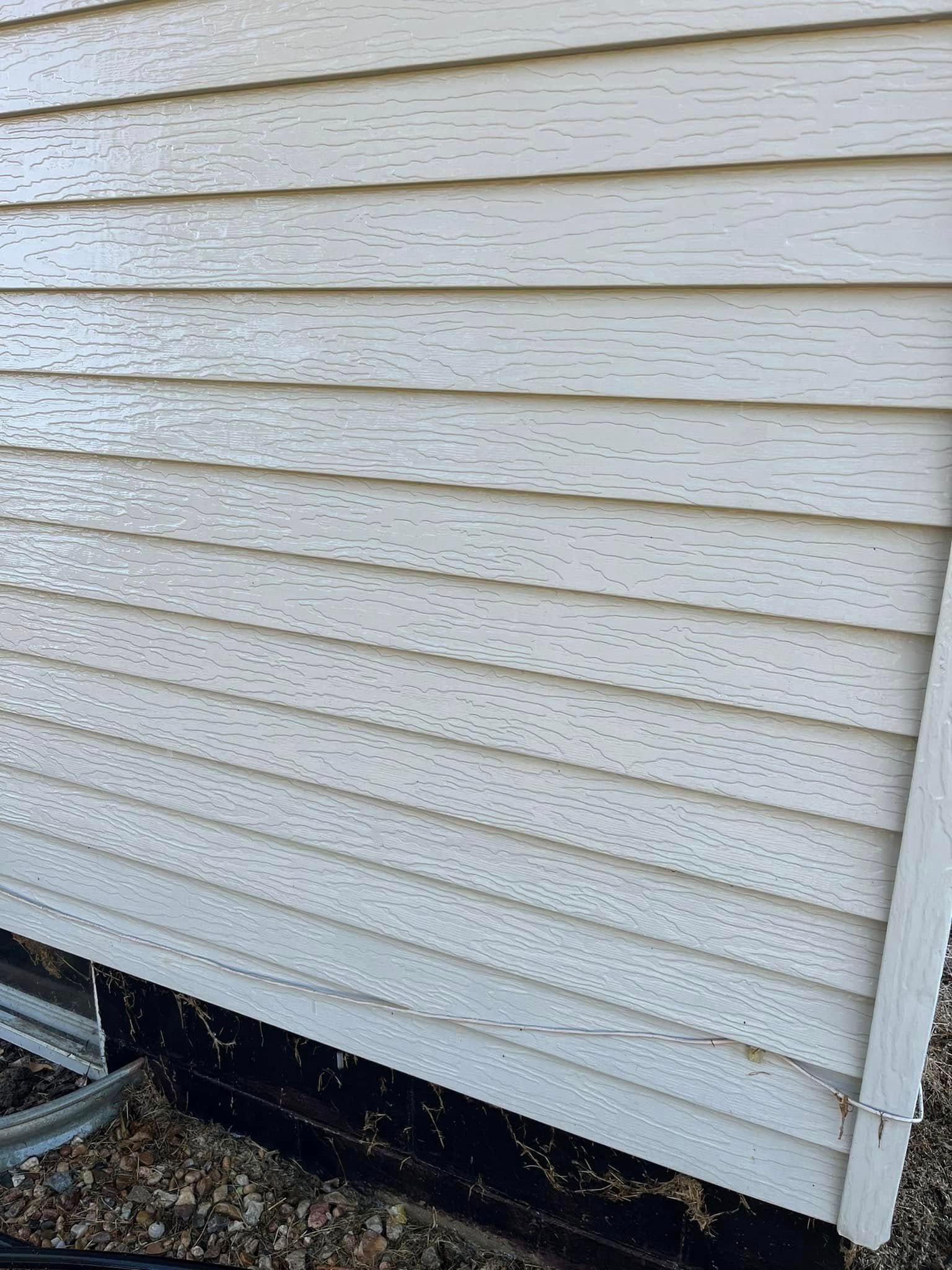 A close up of a white siding on a house.