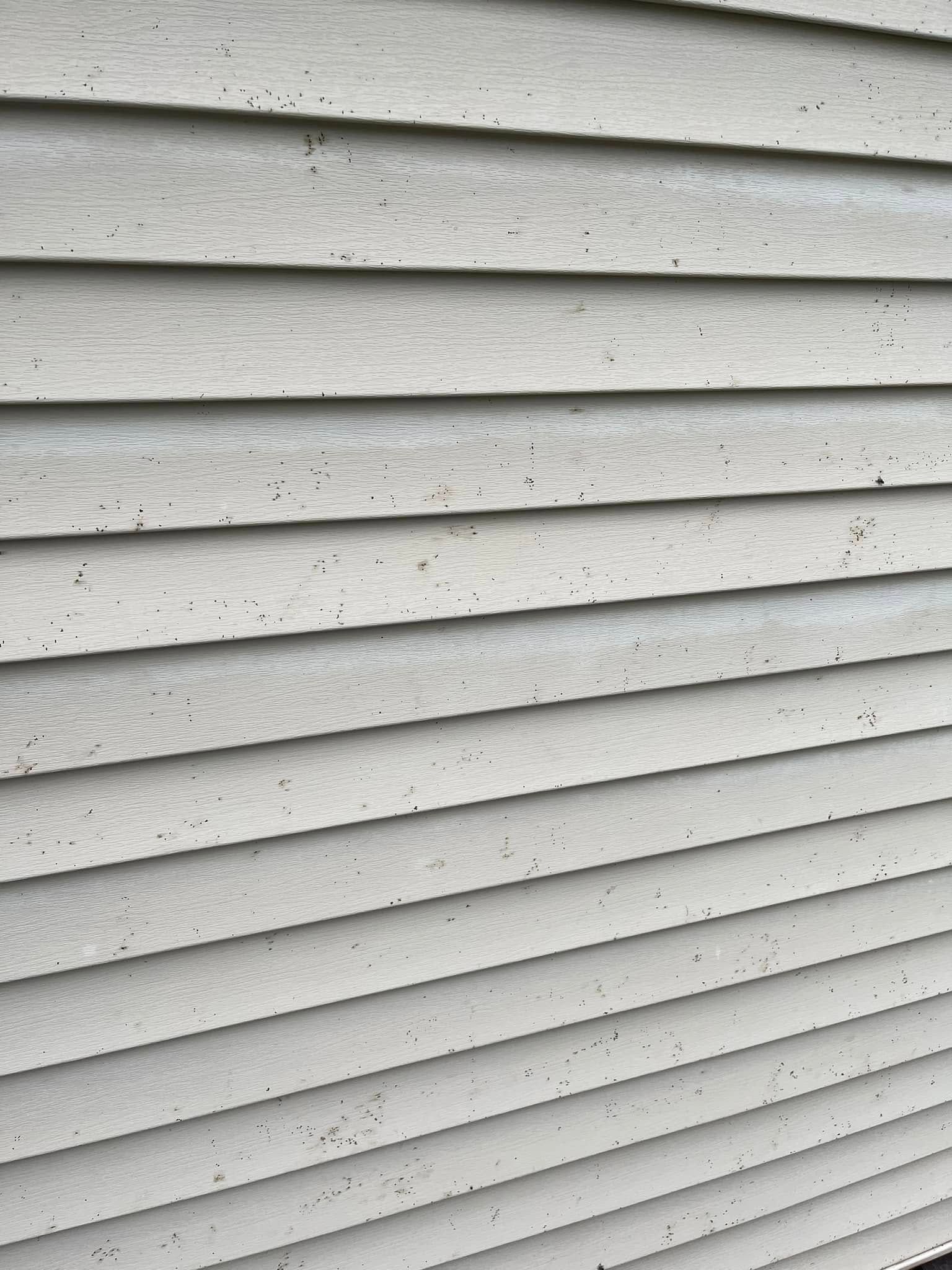 A close up of a white siding on a house