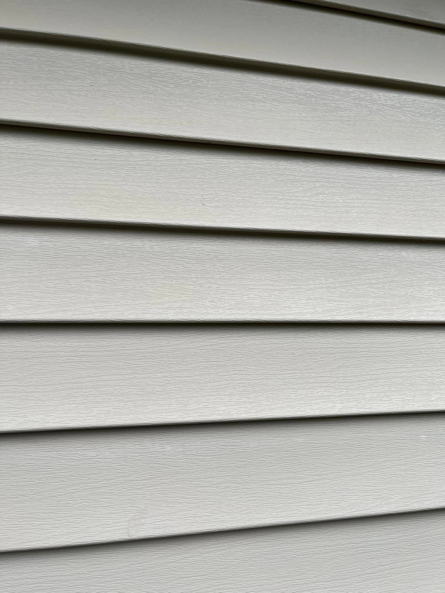 A close up of a white siding on a house.