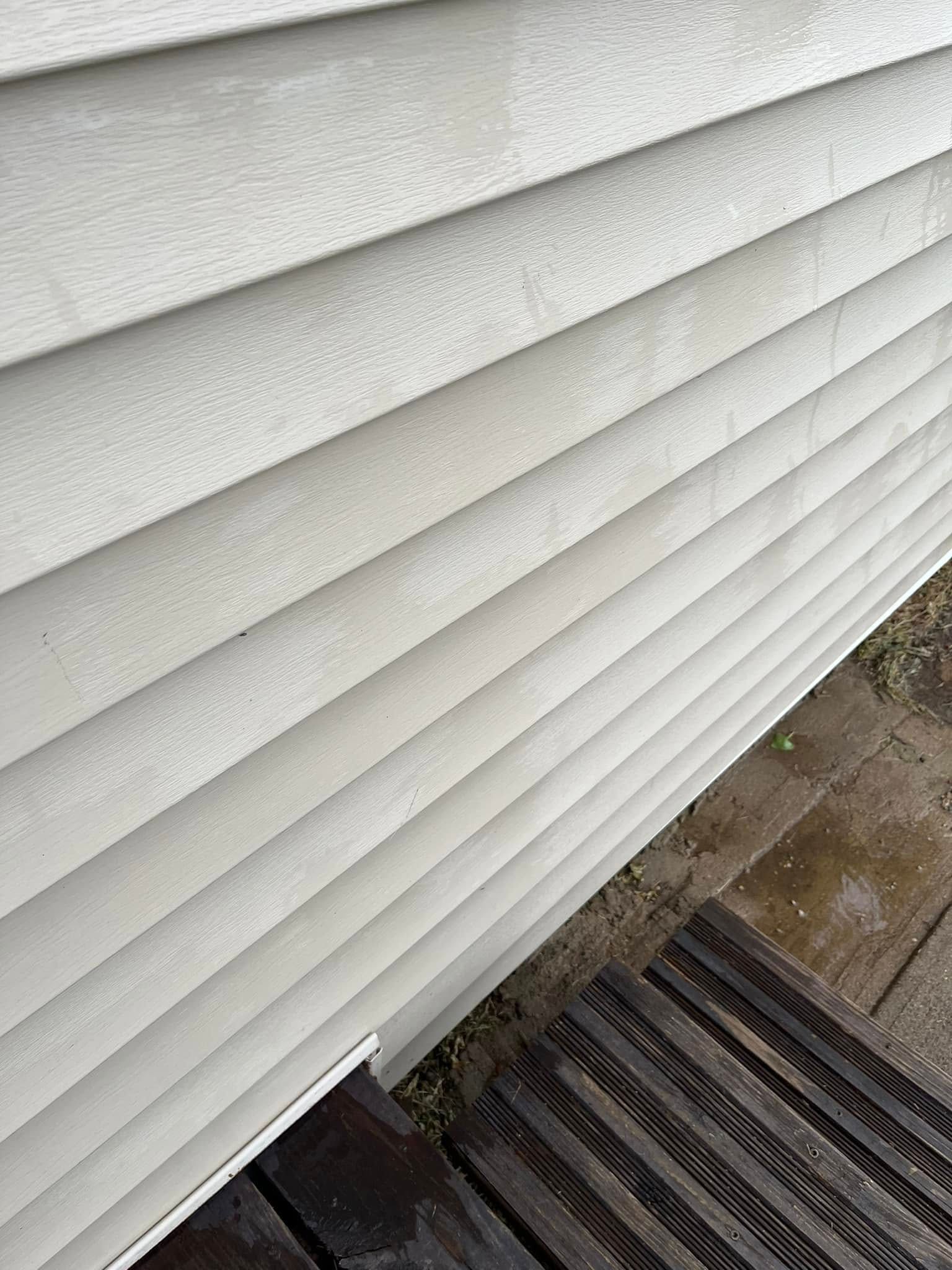 A close up of a white siding on a house.