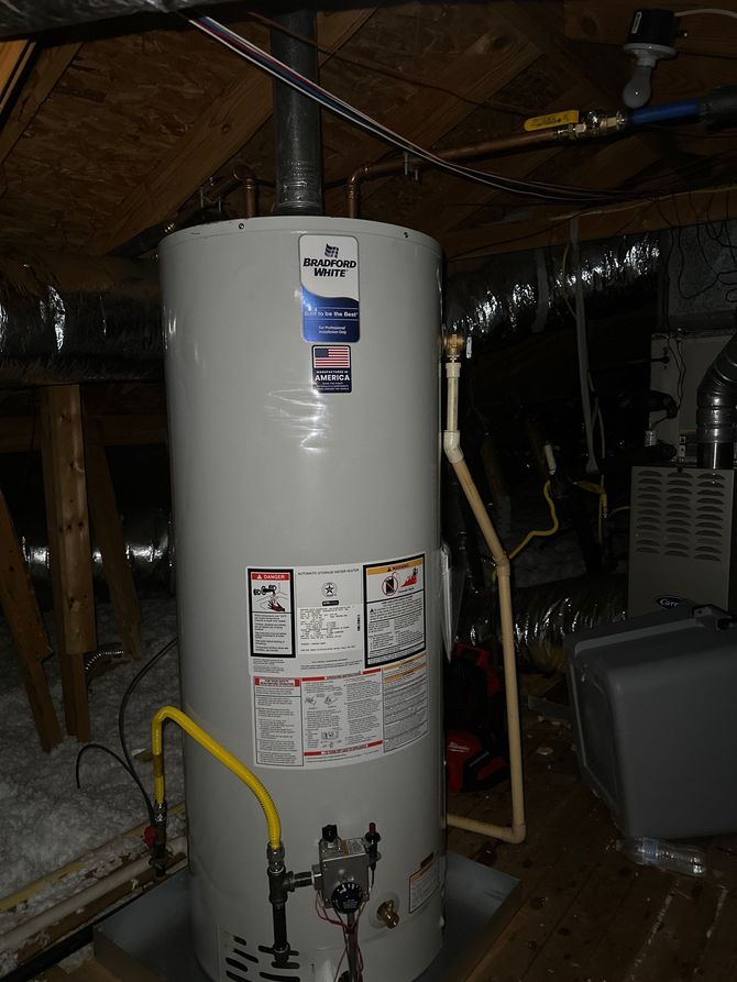 Three large white water softener tanks with control units, connected by black pipes against a wall.