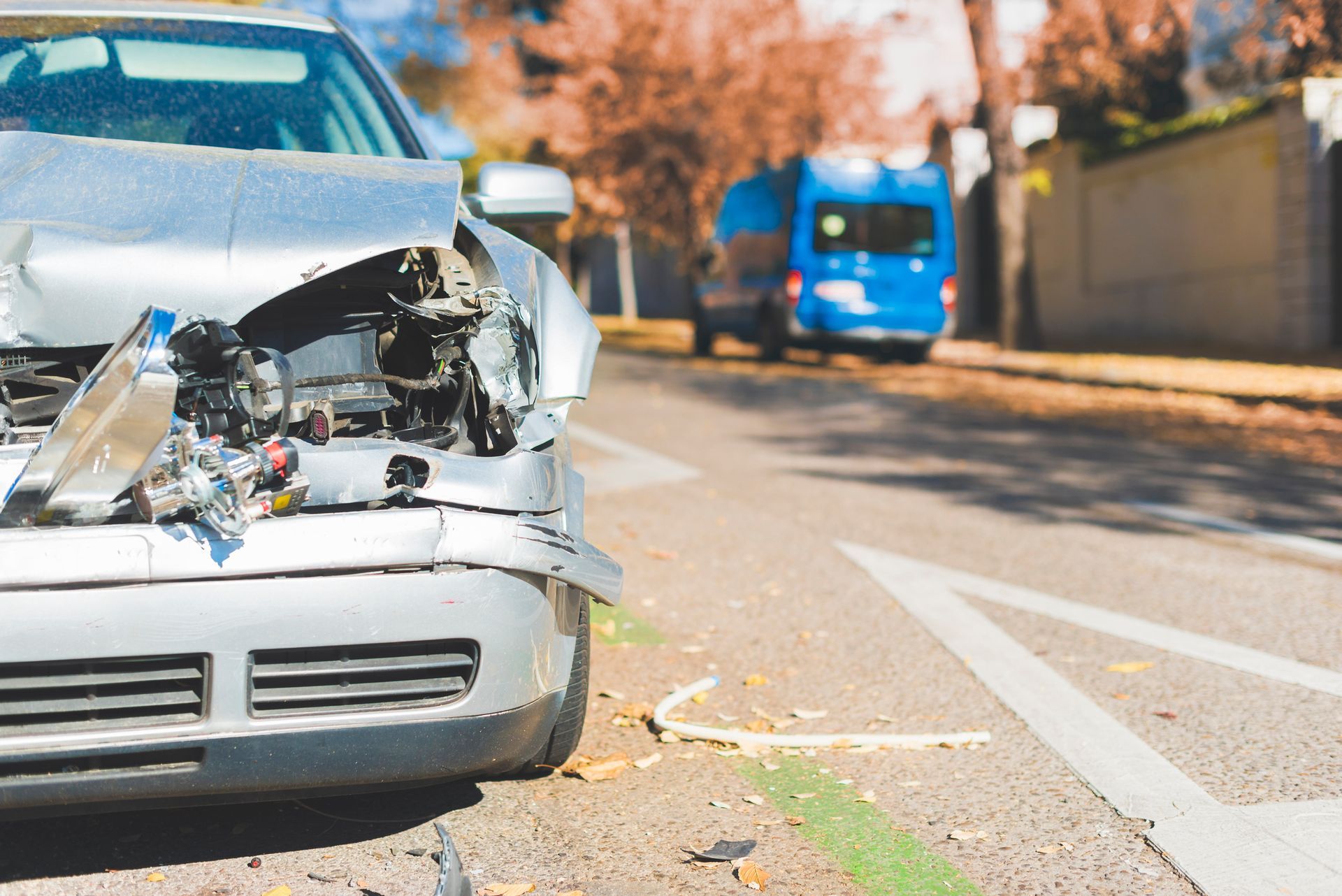 A damaged car is parked on the side of the road.