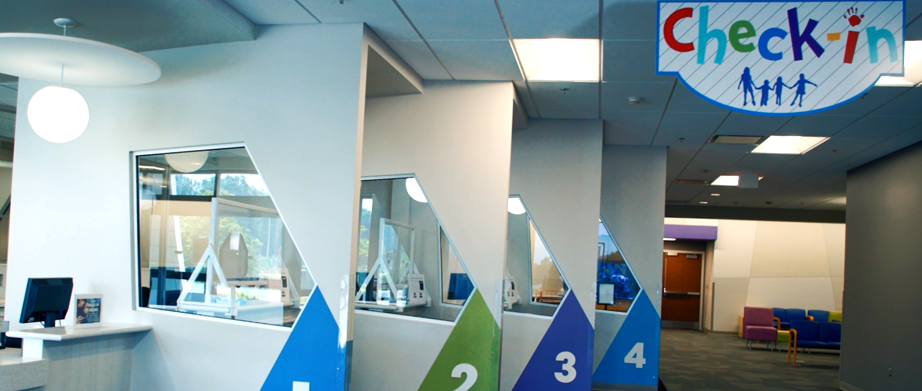 Airport check-in counters with numbered lanes and a “Check in” sign above.
