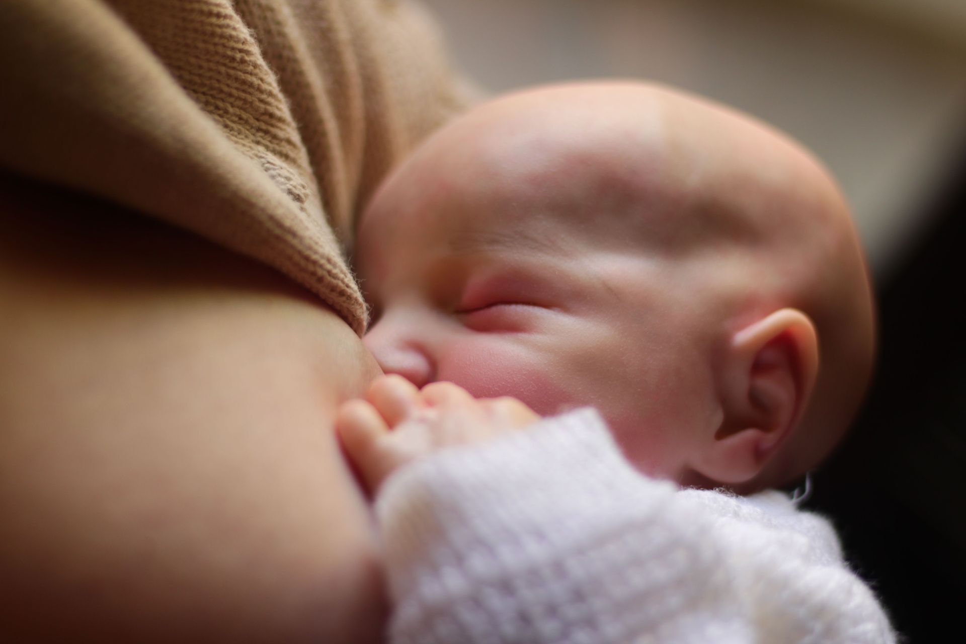 Mother nursing newborn baby