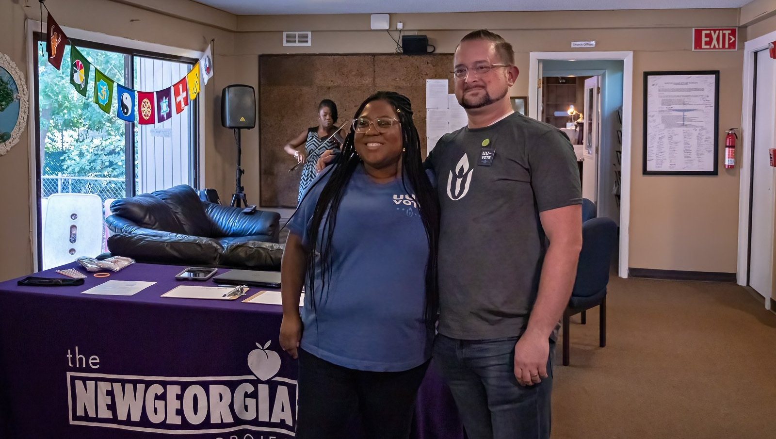 A man and a woman are posing for a picture in a room.