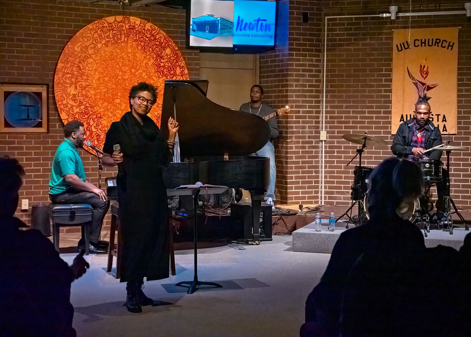 A jazz band is playing in front of a group of people