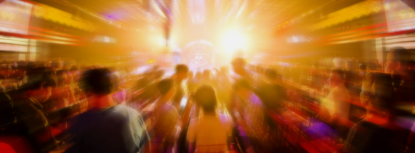 A blurry picture of a crowd of people dancing
