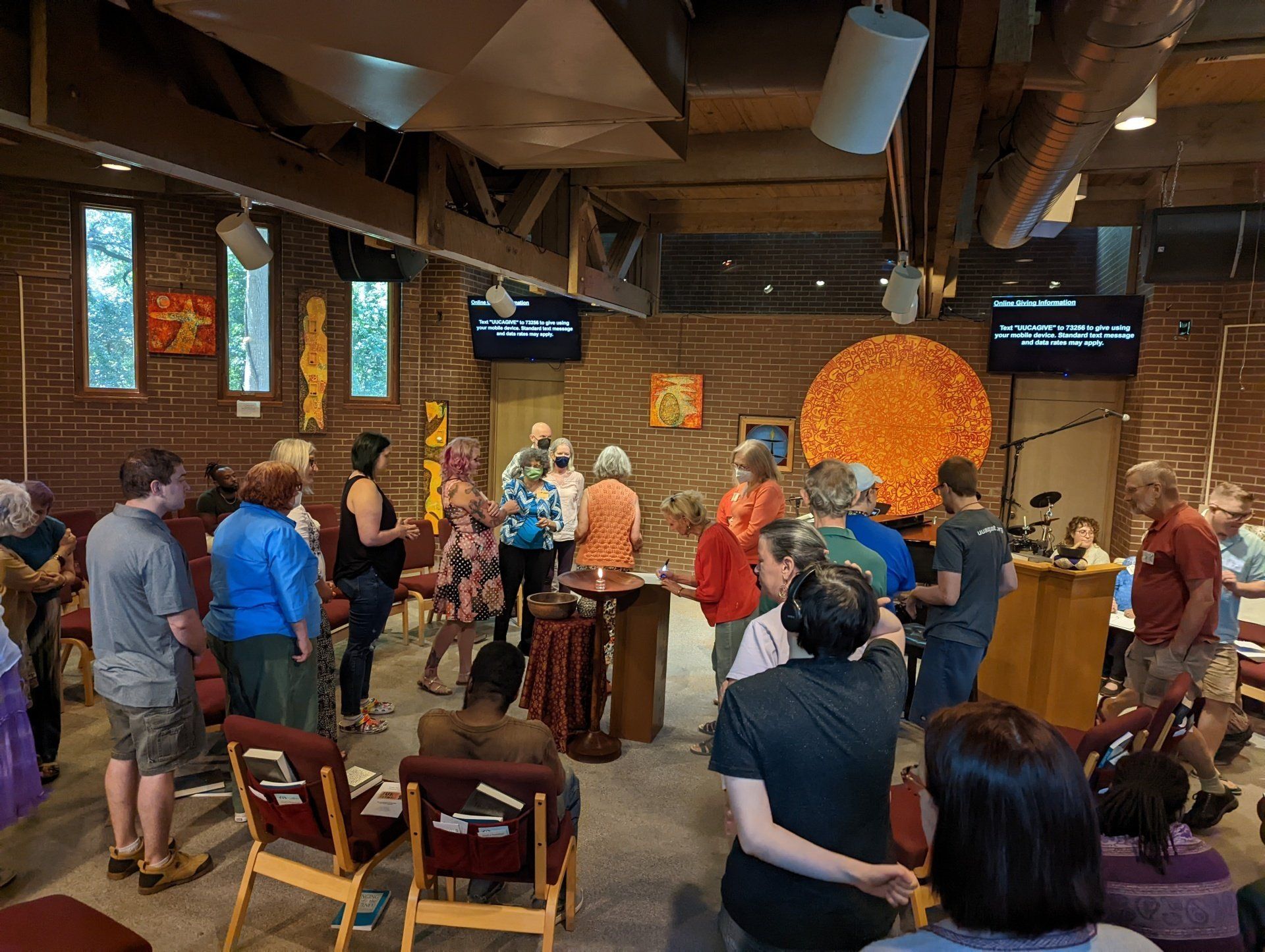 A large group of people are standing in a room.