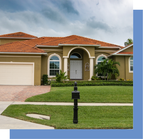 a house with a red tile roof and a white garage door