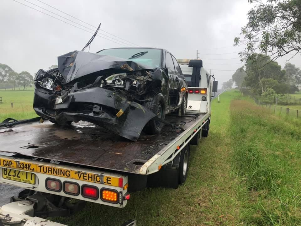 A Damaged Car Is Being Towed by A Tow Truck — Twin Lakes Towing & Recovery in East Maitland, NSW