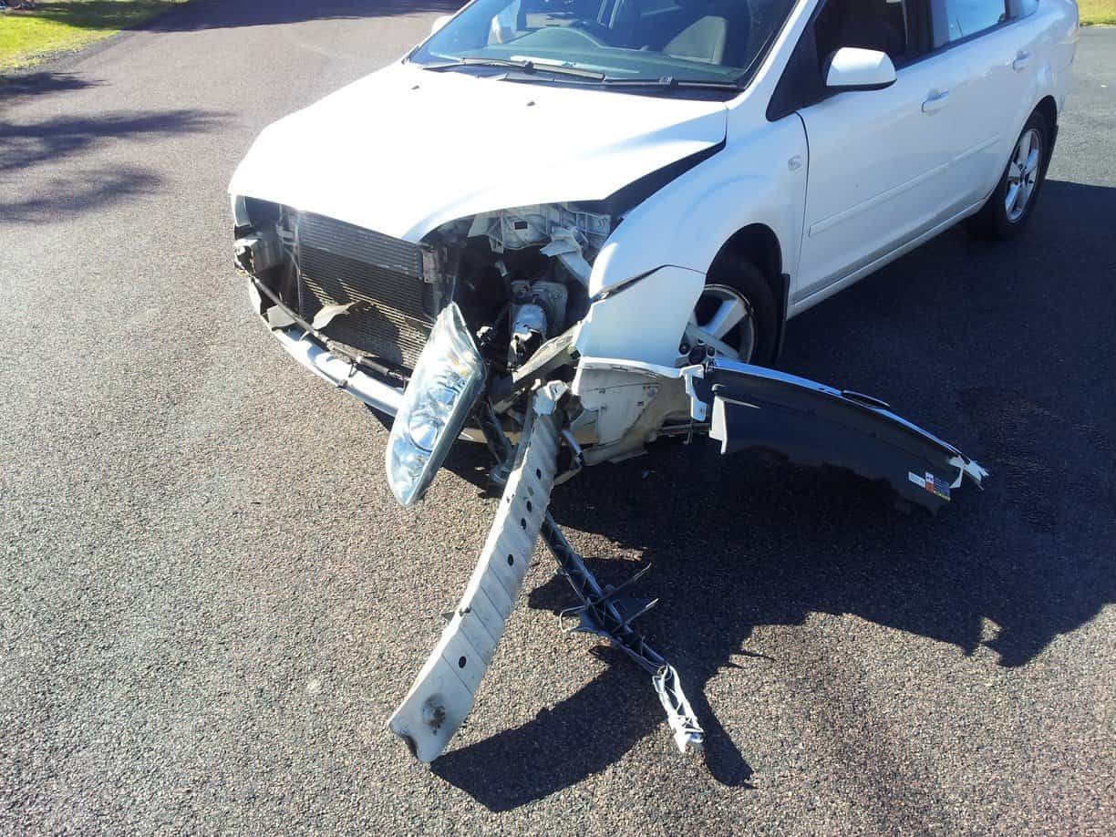 A White Car that Has Been Damaged in An Accident — Twin Lakes Towing & Recovery in Tuggerah, NSW