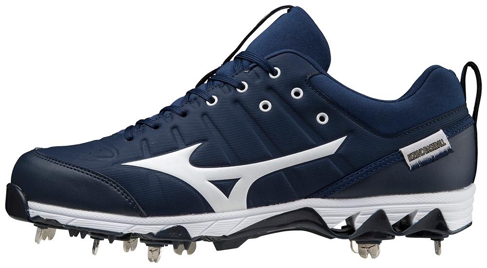 A pair of blue and white baseball cleats with spikes on a white background.