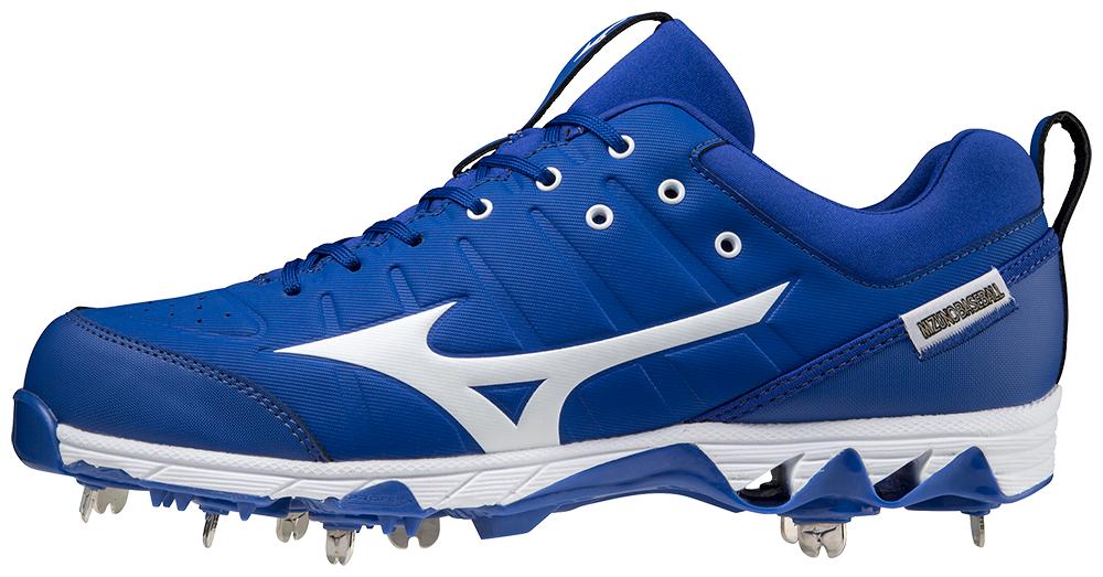 A pair of blue and white baseball cleats with spikes on a white background.