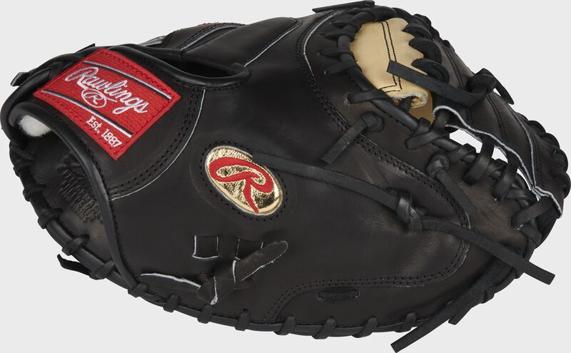 A black rawlings baseball catcher 's mitt with a red label