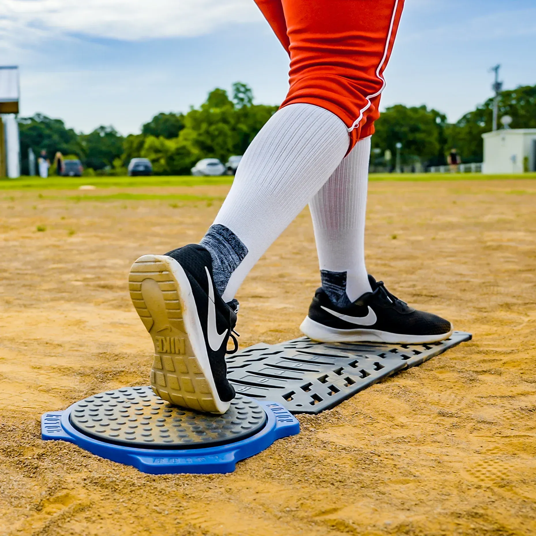 A person wearing nike shoes is standing on a manhole cover