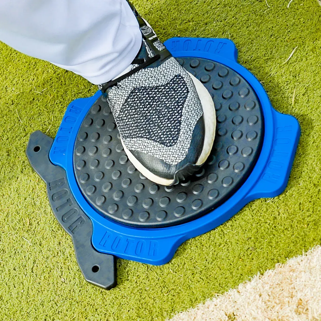 A person 's foot is on a blue and black item that says ' agility ' on it