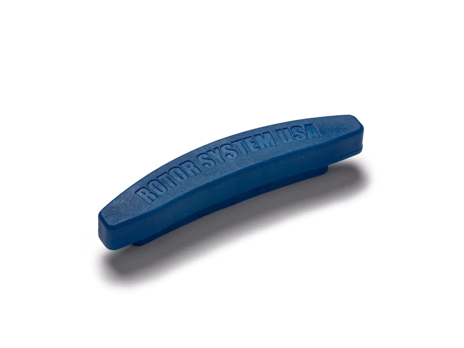 A blue rubber bar with the word rubber on it is sitting on a white surface.