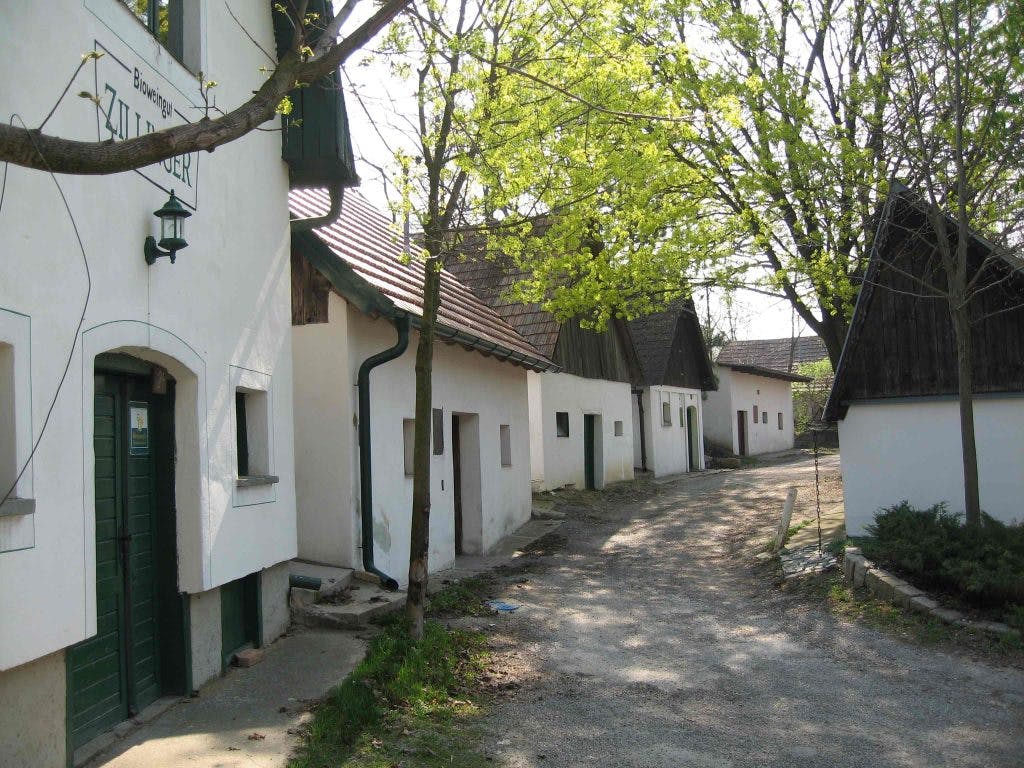 A traditional cellar lane at Zillinger, with historic winery buildings lining a quiet rural path.