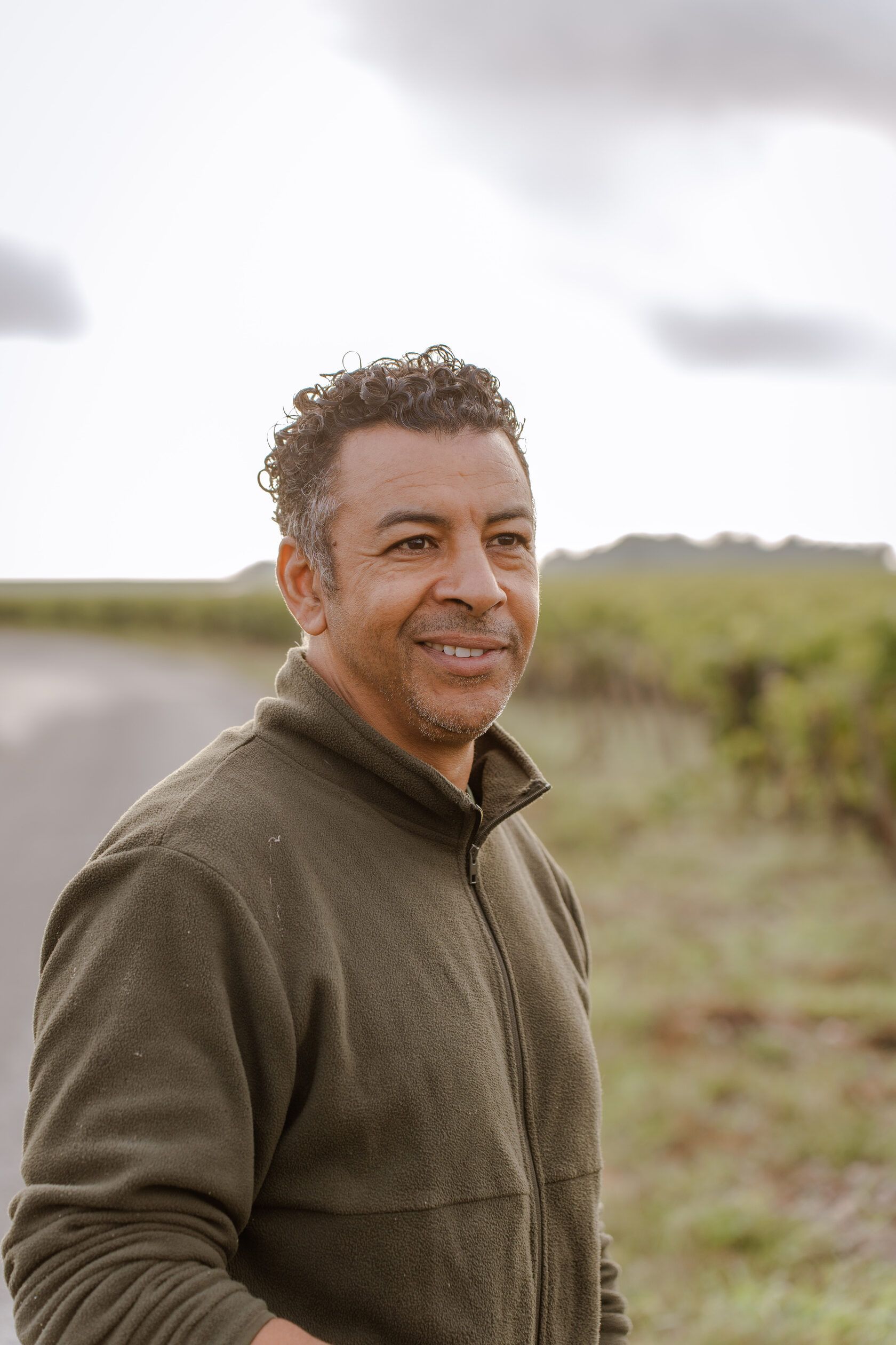 Winemaker of Château Tour des Termes smiling in the vineyard