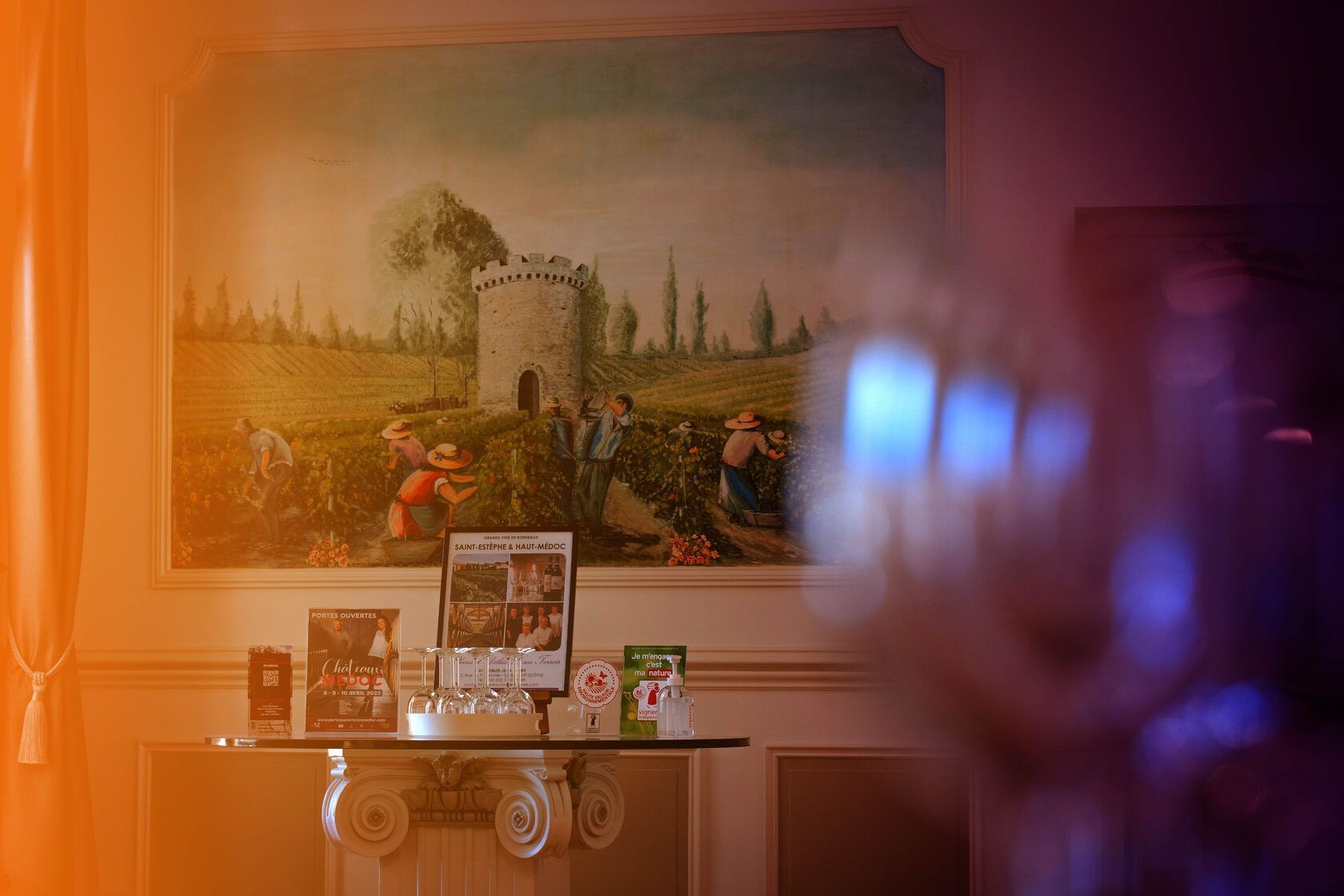Interior tasting room with vineyard mural and tasting table at Château Tour des Termes