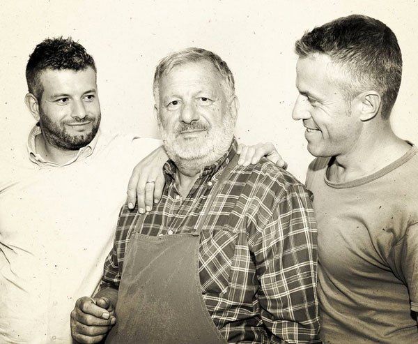 The three Barbacàn winemakers, all smiling, in a bright setting.