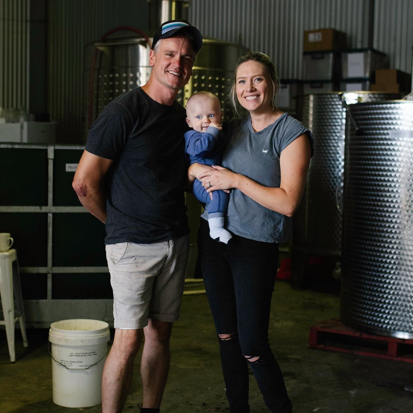 Family of three, smiling, in Bondar winery.