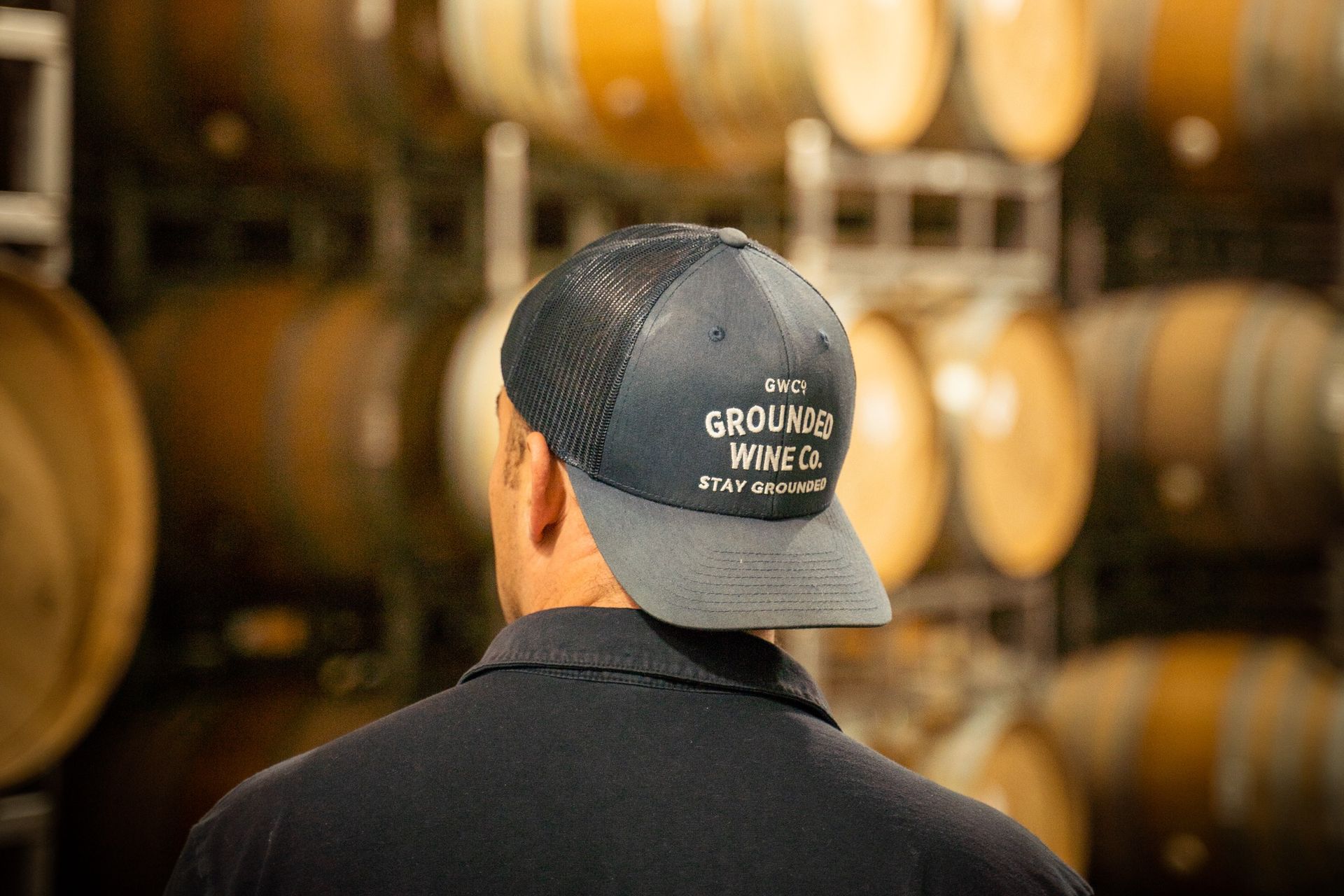 A winemaker of Grounded Wine Co. inside a barrel room.