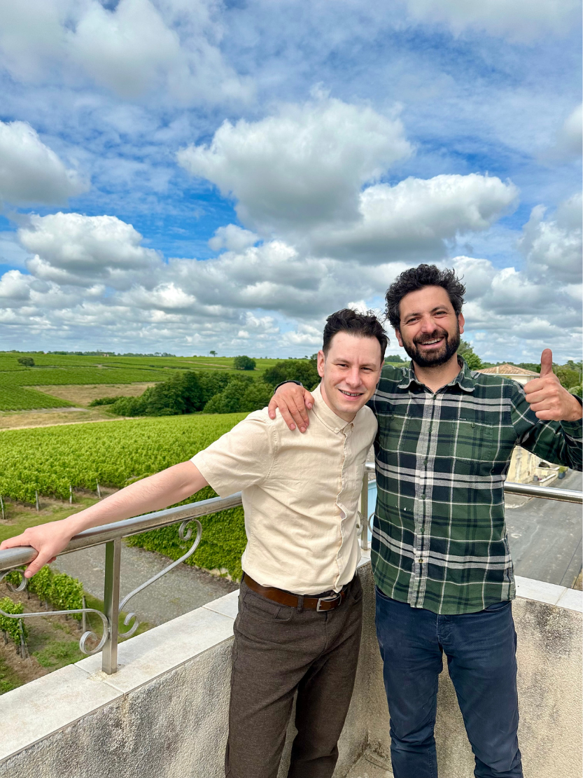 Winemaker from Château Haut Grelot with a Vino al Vino team member at the estate vineyard.