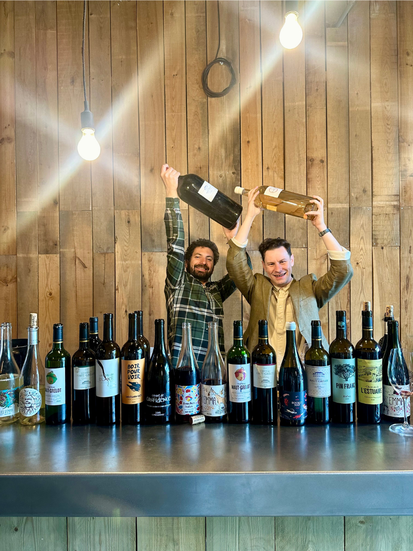 Château Haut Grelot winemaker with a Vino al Vino team member behind a lineup of wines.