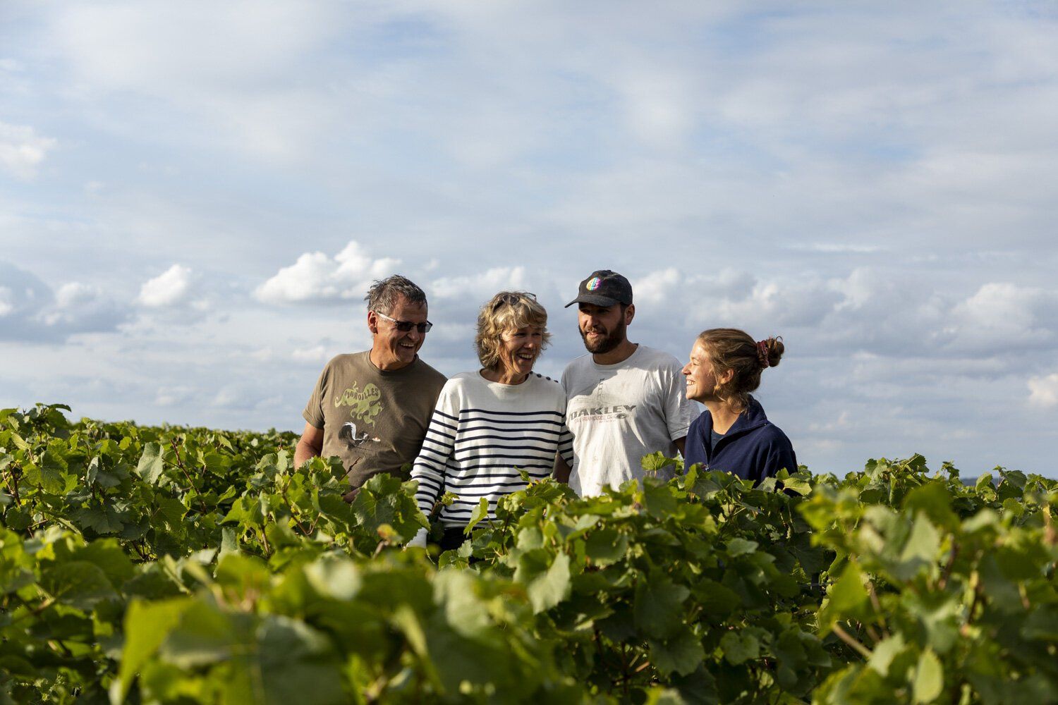Team of Champagne Lelarge-Pugeot in the vineyard, smiling.