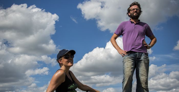 Winemakers of Luneau Papin standing against a cloudy blue sky