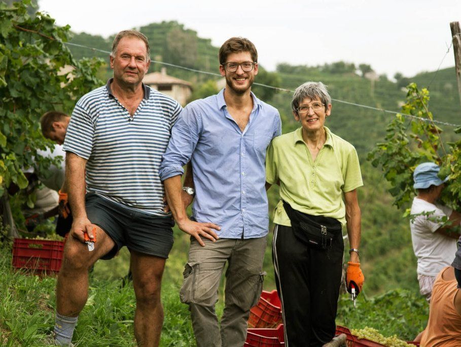 Three people in a vineyard, posing for the camera at Mongarda vineyard.