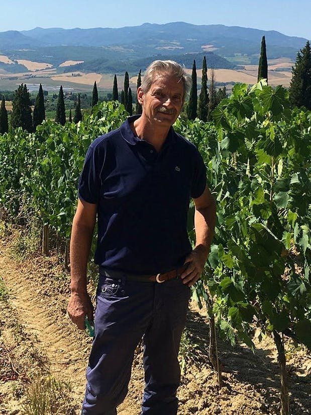 Venturini Baldini vineyard scene showing hands-on viticulture in the rolling hills of Emilia-Romagna.