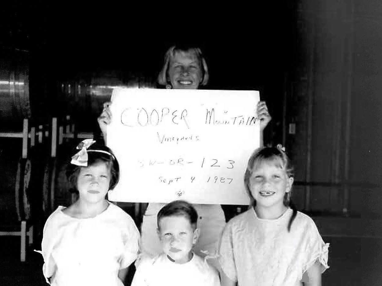 Group of four children holding a sign that reads