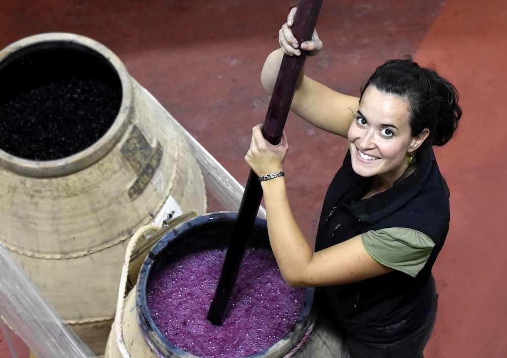 Sandra Bravo, winemaker of Sierra del Toloño, working with fermenting grapes in the cellar