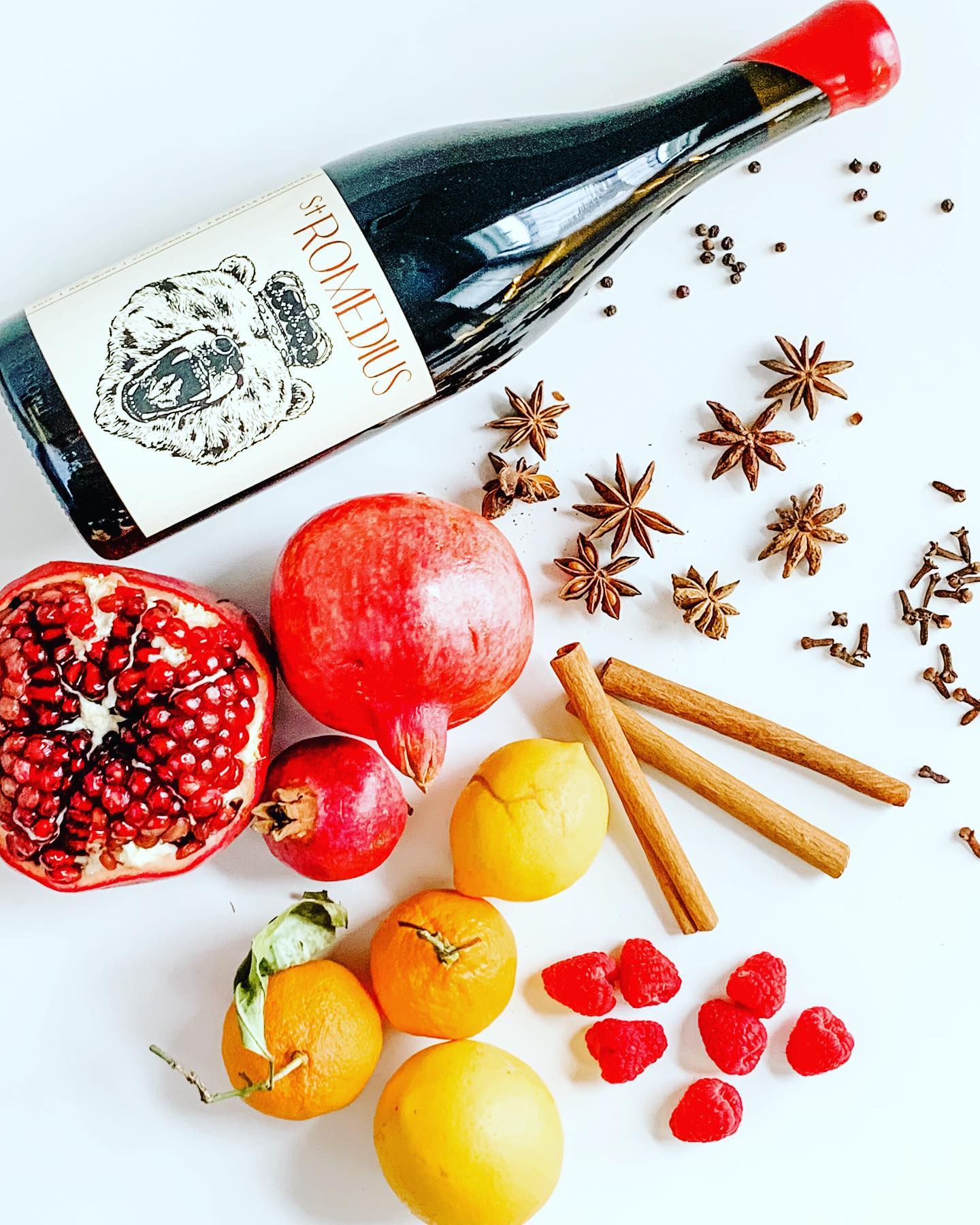 St. Romedius winery bottle styled with fruit and spice still-life.