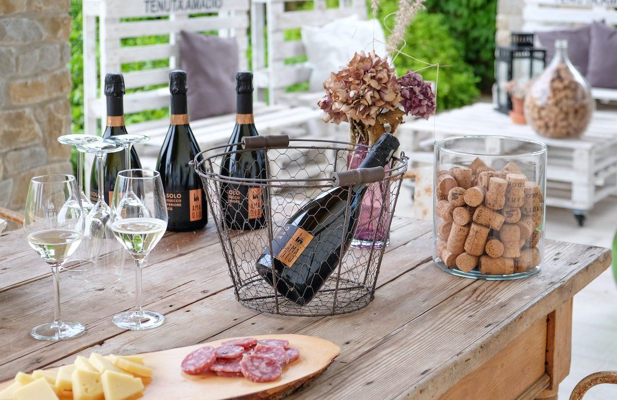 Table with glasses, corks and wine bottles at Tenuta Amadio.