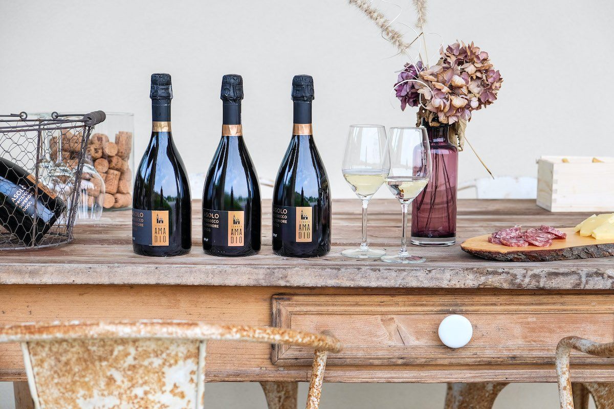 Wine bottles with glasses and charcuterie at Tenuta Amadio