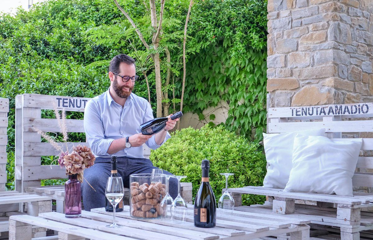 Winemaker examining a wine bottle at Tenuta Amadio