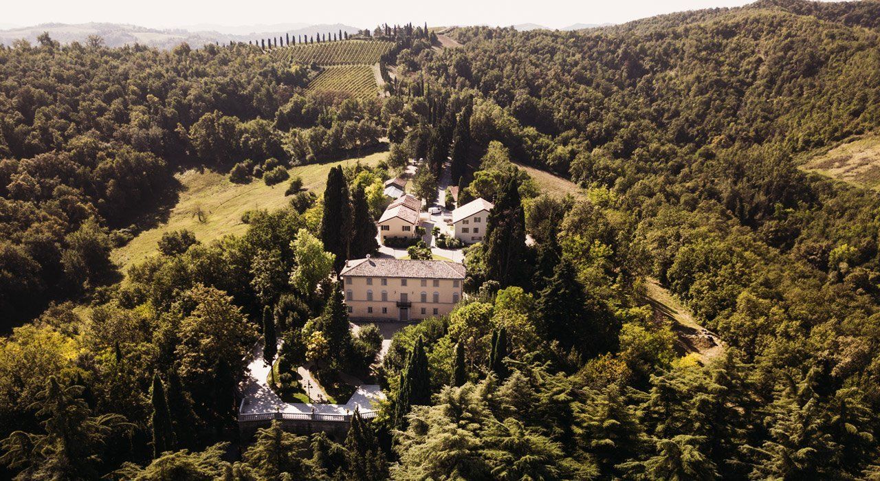 Venturini Baldini estate surrounded by vineyards and woodland, showcasing the winery’s historic terroir.