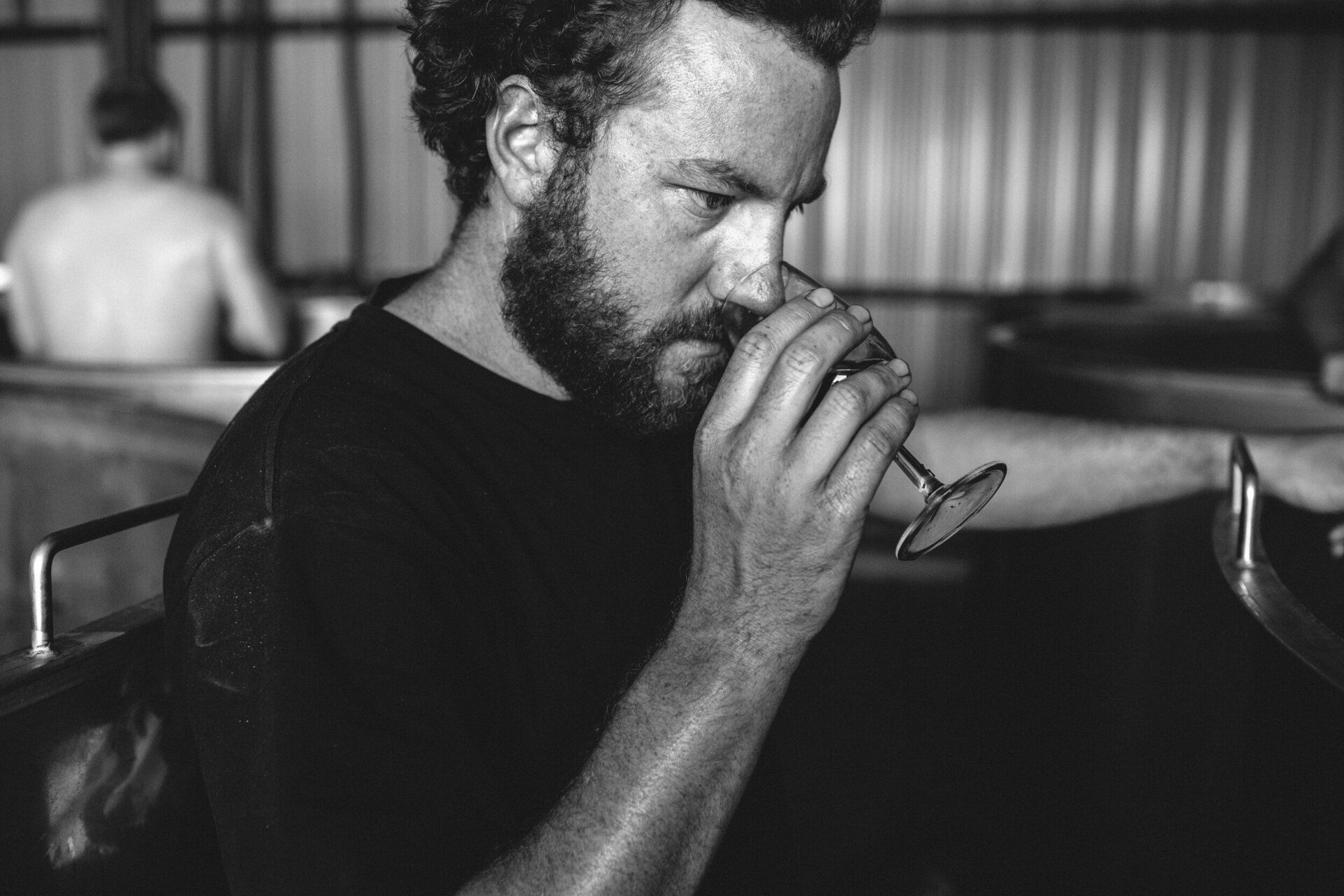 Xavier Goodridge from Jumping Juice tasting the aroma in the cellar.
