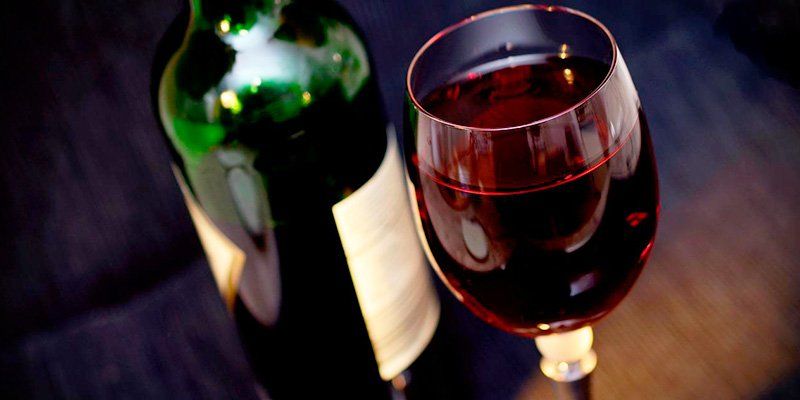 a bottle and a glass of wine a bottle and a glass of wine