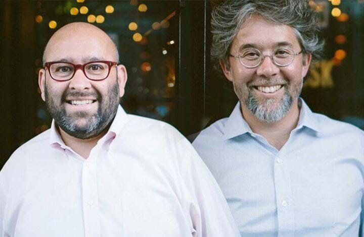 Two men smiling near a glass door, at Sandhi winery