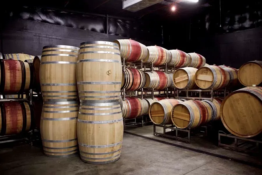 Wooden barrels stacked and stored in Sandhi wine cellar
