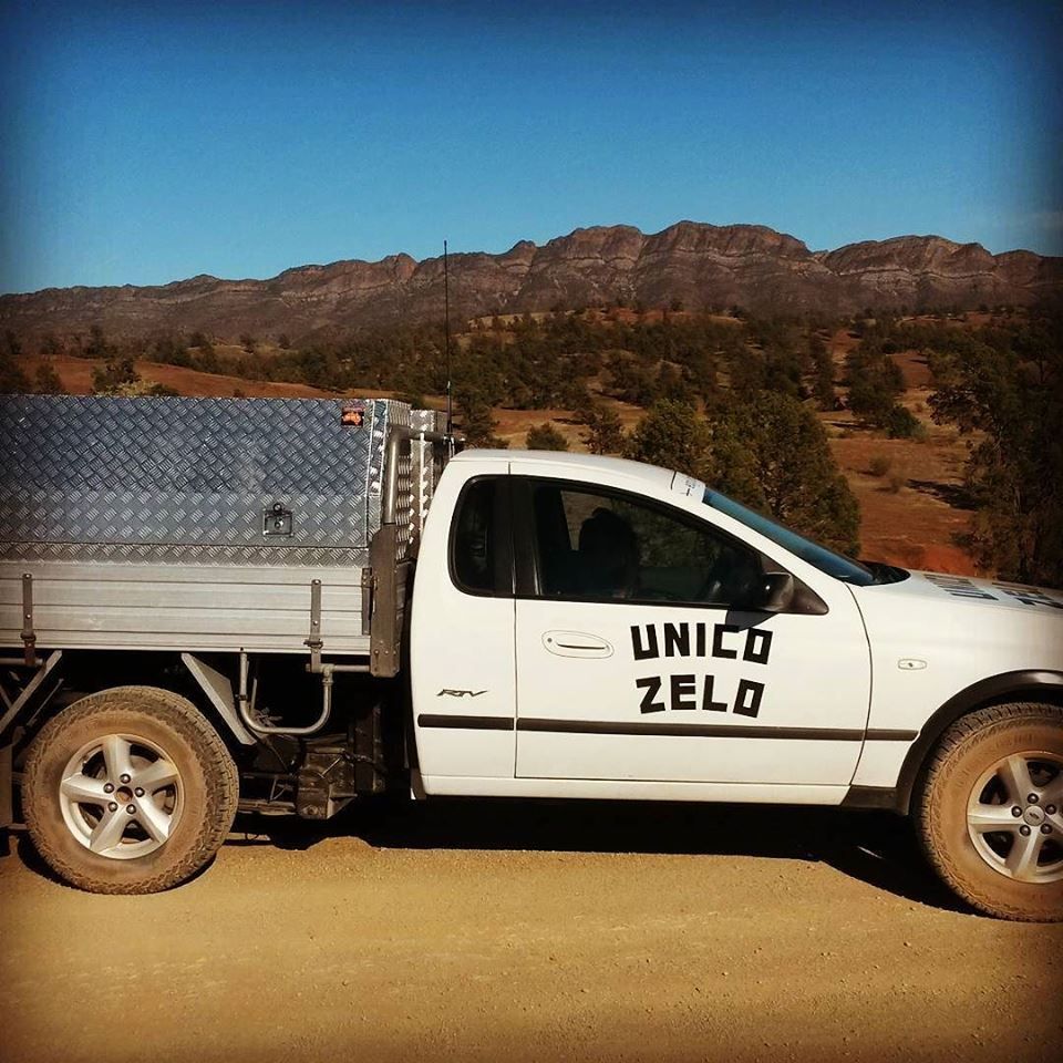 Unico Zelo white truck parked on the vineyards in front of mountains on a sunny day.