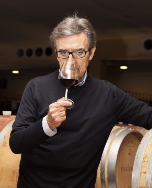 Venturini Baldini winemaker tasting red wine in the cellar, highlighting craftsmanship and barrel aging.