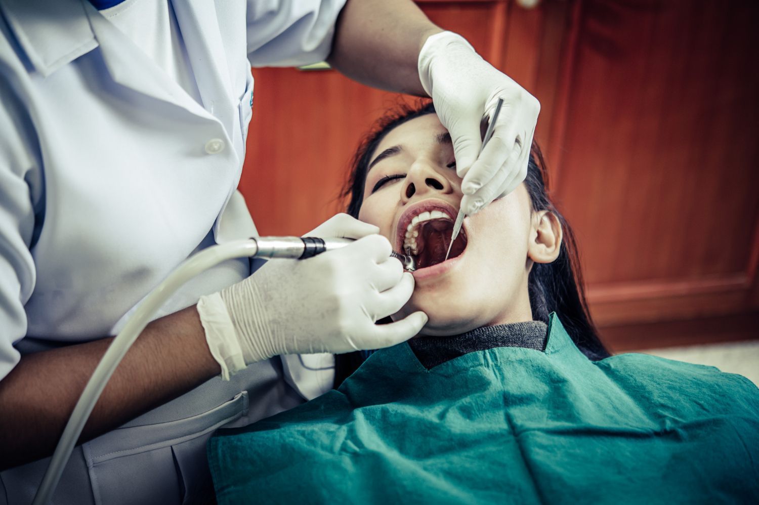 woman at dentist gettin teeth cleaned