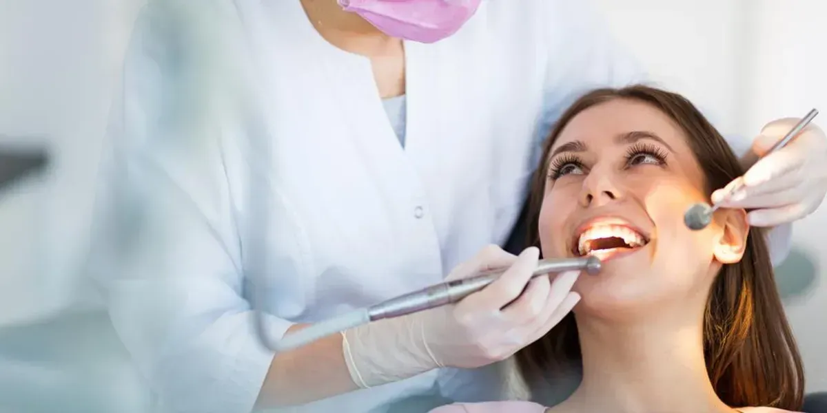 AMENITIES & COMFORTS | woman smiling at dentist with mouth open | Garland TX 75040