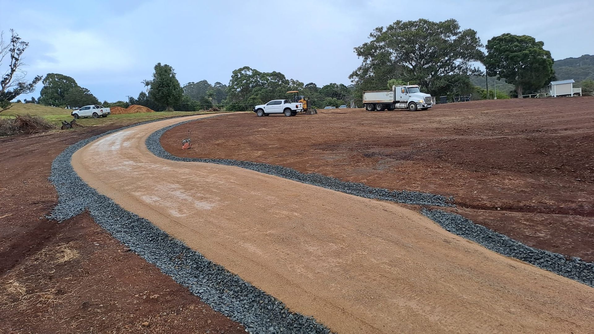A Dirt Road Going Through a Field — East Point Earthmoving in Byron Bay, NSW